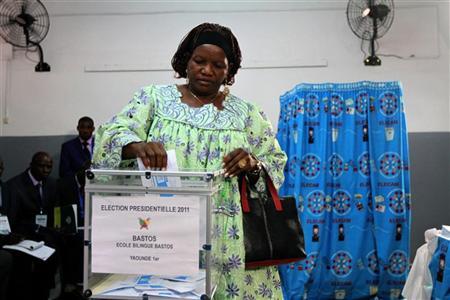 A woman casts her vote at a polling unit during the presidential election in Cameroon's capital Yaounde October 9, 2011. 
